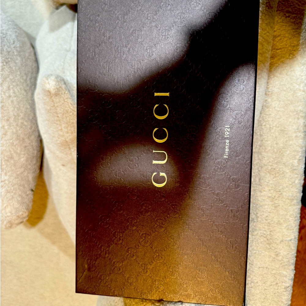 Black leather GUCCI thong.